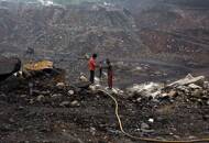 FILE PHOTO: Workers drill at an open cast coal field at Dhanbad district in Jharkhand