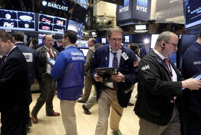 FILE PHOTO: FILE PHOTO: Traders work on the floor of the New York Stock Exchange (NYSE) shortly after the opening bell of trading session in New York