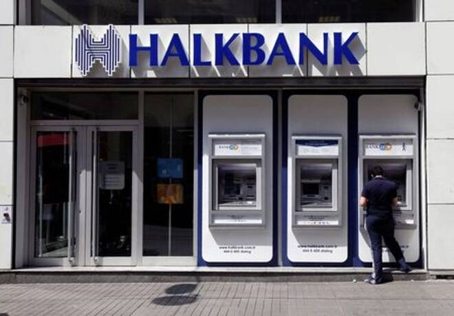 FILE PHOTO: A customer uses an automated teller machine at a branch of Halkbank in Istanbul