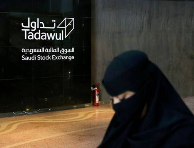 Saudi woman walks at the Saudi stock market