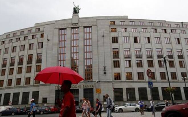 FILE PHOTO: A man holds an umbrella in front of the Czech National Bank in Prague