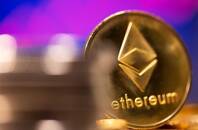 FILE PHOTO: A representation of virtual currency Ethereum is seen in front of a stock graph in this illustration