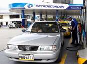 A worker pumps fuel into a car at a Petroecuador gas station in Quito