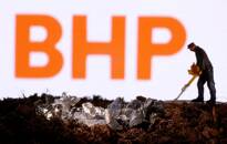 FOTO DE ARCHIVO: Una pequeña figura y una imitación de mineral delante del logo de BHP