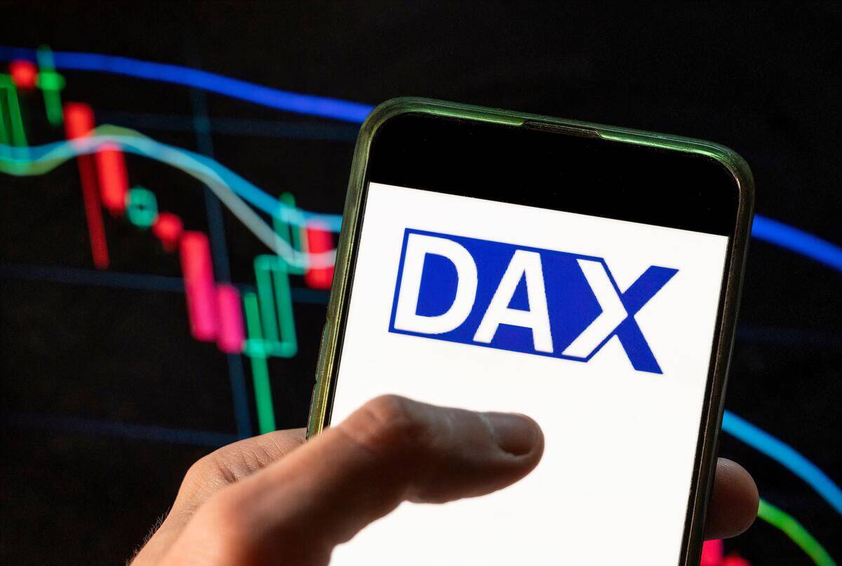 China. 4th Dec, 2021. In this photo illustration the German stock market index DAX logo seen displayed on a smartphone with an economic stock exchange index graph in the background. (Credit Image: © Budrul Chukrut/SOPA Images via ZUMA Press Wire)