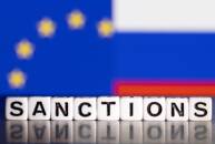 Una bandiera Ue e una bandiera russa dietro a una serie di dadi con la scritta "Sanctions"
