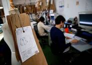 Persone lavorano in una fabbrica tessile di Madrid